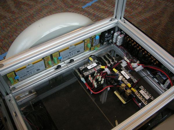 inside of the base of the robot, showing DC regulation modules, terminal blocks, and the back side of indicators and switches
