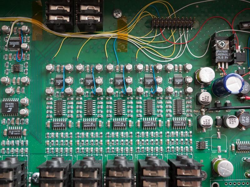 close-up of the D/A section of the main board showing detail of wires
        added to configure the mode of the converters and route digital audio
        to the glued-on header